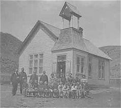 Upton School with students and teachers posed in front in black and white.